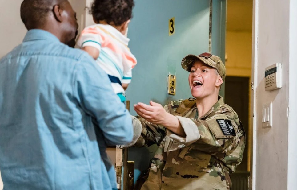 Image of a military mom coming home to her husband and child.