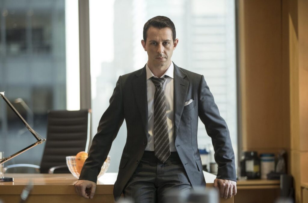 Image of Kendall Roy leaning on a desk.