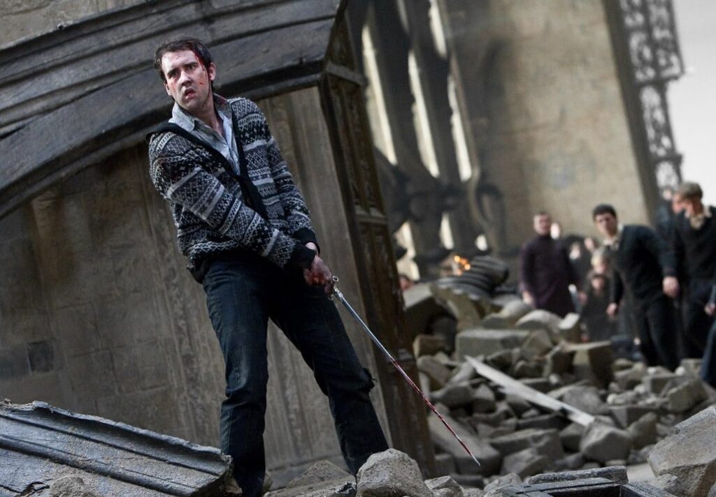 Image of Neville holding a bloodied sword. 