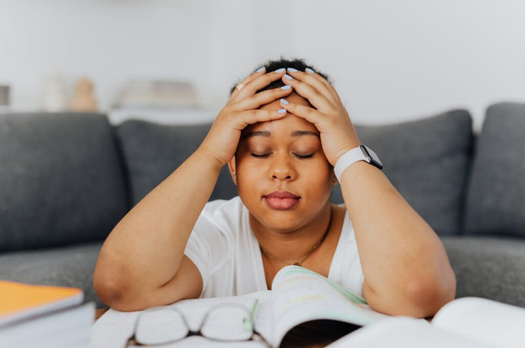Woman with hands on her head.