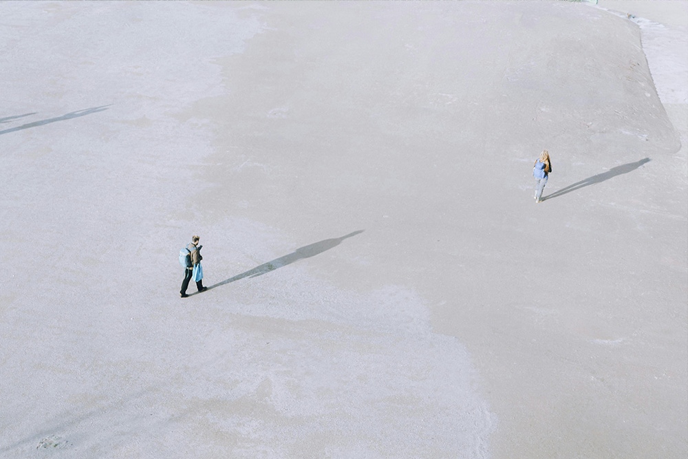 A man very far from a woman to suggest the distance between your work and your reader.