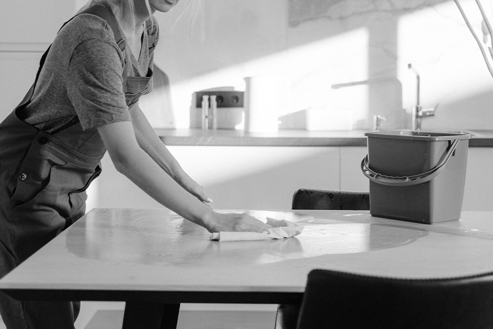 A woman cleaning a table to illustrate the pointlessness of going back to review old pages