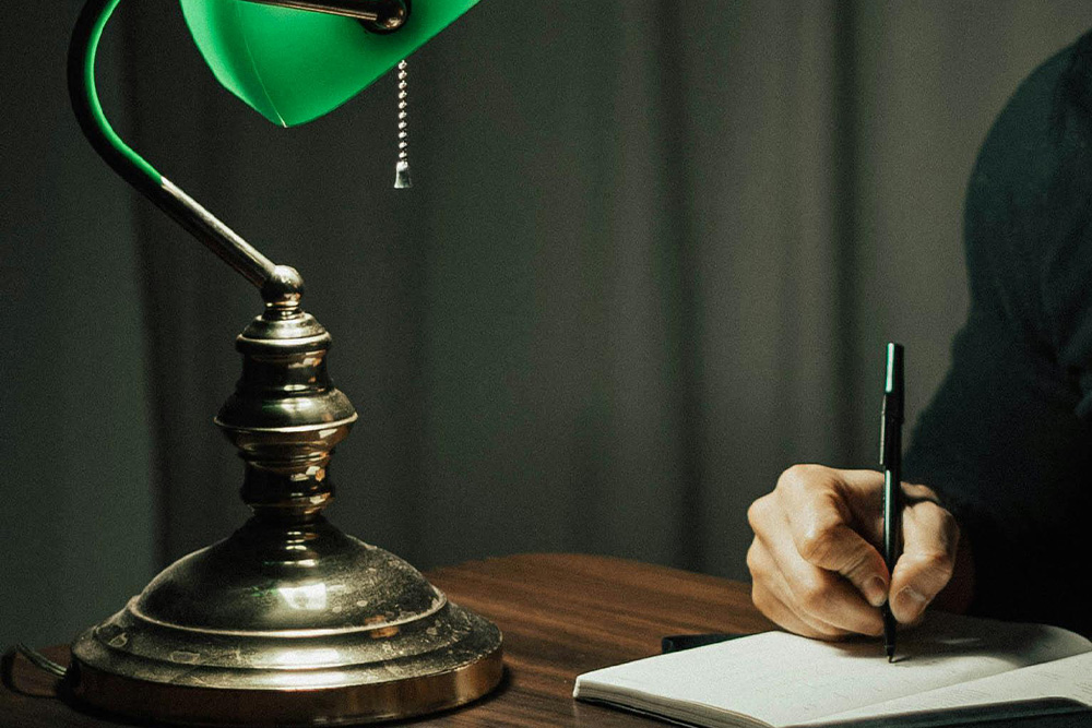 Open journal under a standard library light--the nature in which work reveals its own quality in a focused manner