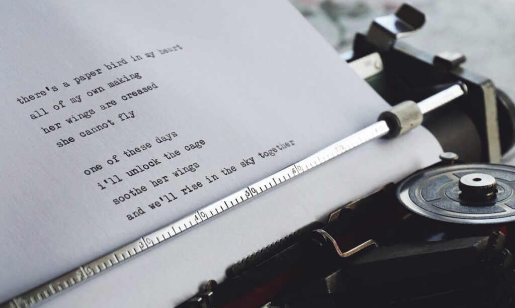 Image of a poem being written on a typewriter.