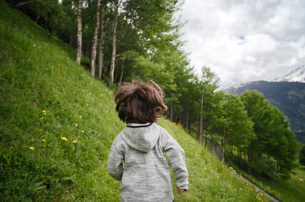 Image of a kid running on a hill. 