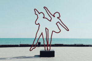 Featured image for character outlines with two outlines of people dancing by the beach in red to depict a visual importance that exists naturally in all mediums