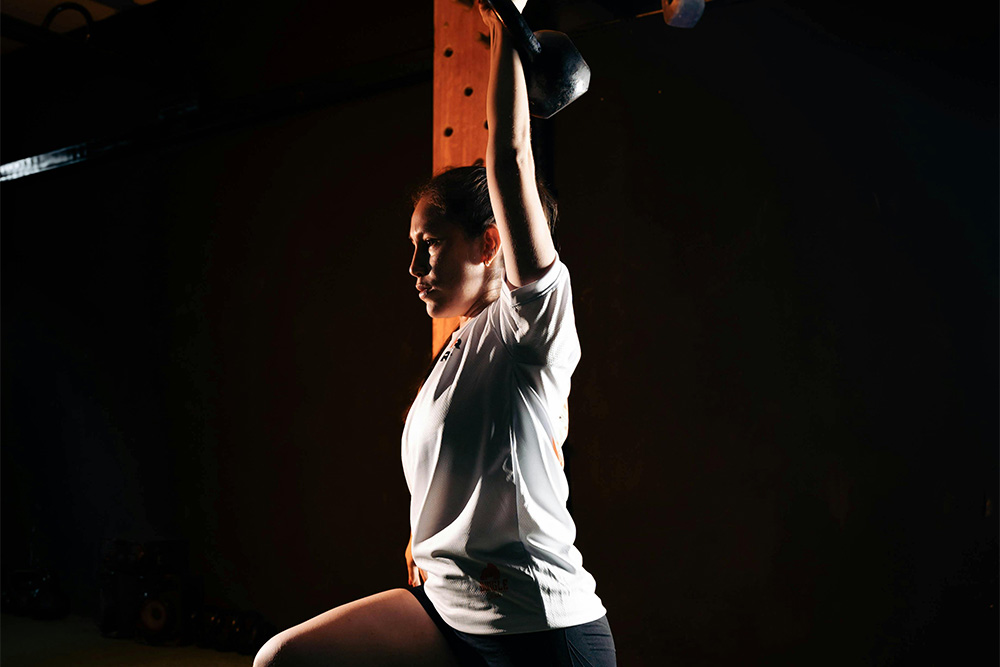Flash fiction is the practice of fundamentals, see here an athlete training strength in an undecorated gym as a visual parallel for the writing of flash fiction as exercise in process