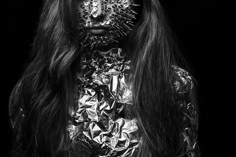 A woman set in foil and pins to her face to quickly visualize the concept of foil characters