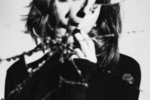 A character in a broken mirror to visualize the stark nature of depicting internal conflict for a character in narrative