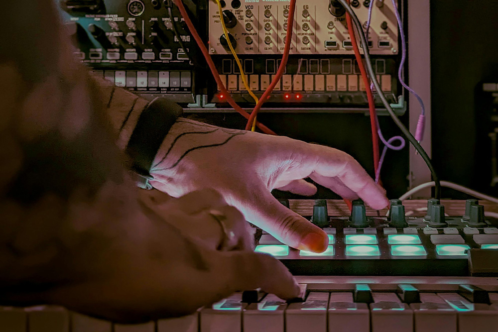 Nondescript hands playing various instruments to visualize how dissonance can be achieved by using various instruments but still create a desired effect