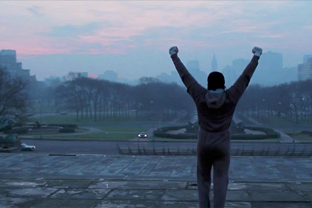 Rocky Balboa at the top of the Philadelphia staircase to demonstrate the rounding of his character in the film
