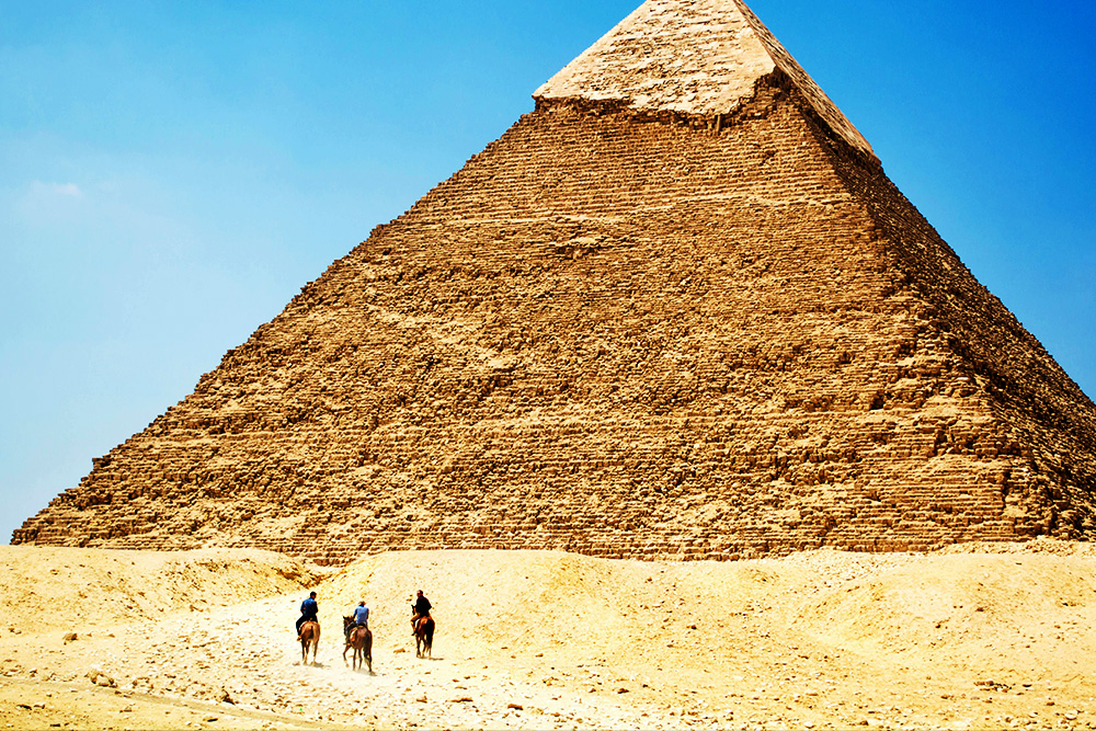 Freytag's Pyramid visualized with the dramatic opening of three people on horseback--some kind of characters--preparing to embark on some kind of journey toward the pyramid itself
