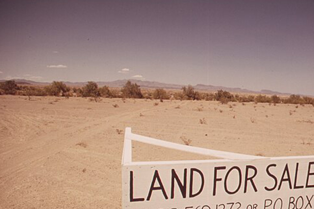 A big empty plot of land for sale to visualize context for the origins of the word "plot" as used to describe a scheme for story