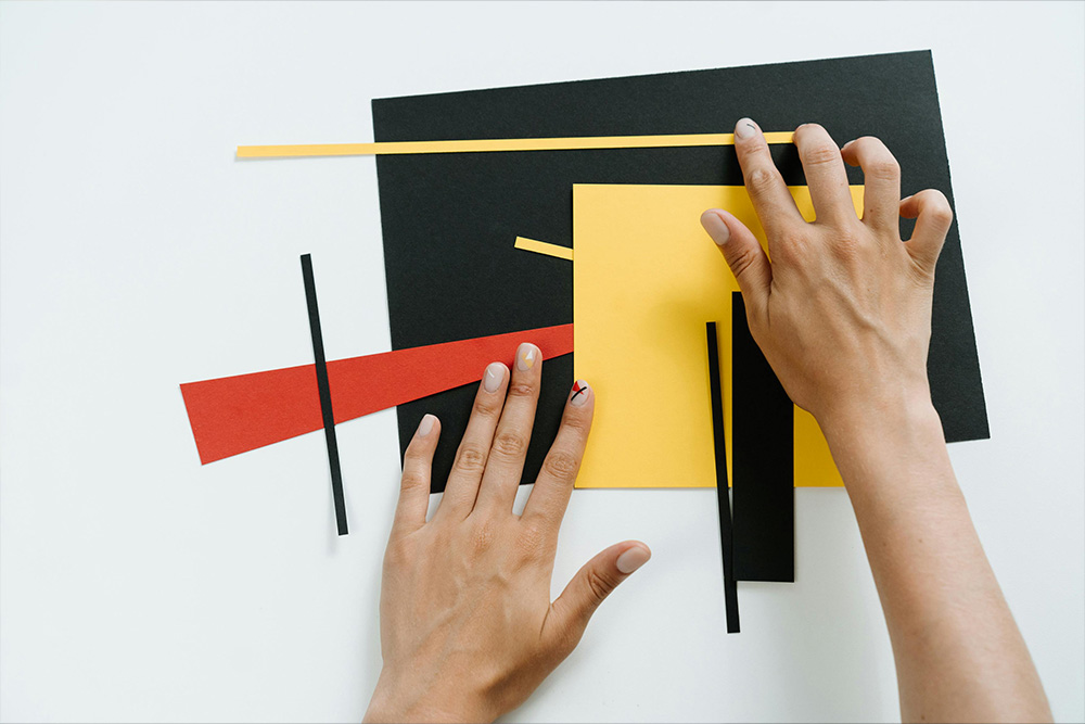 Different pieces of colored papers are put together in a large mess as a part of a greater composition, but are waiting for a "rewrite" to be put in a straight line.
