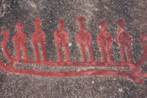 Prehistoric cave archeological cave carving of six men in a boat used to symbolize the deep meaning of a 6-word memoir