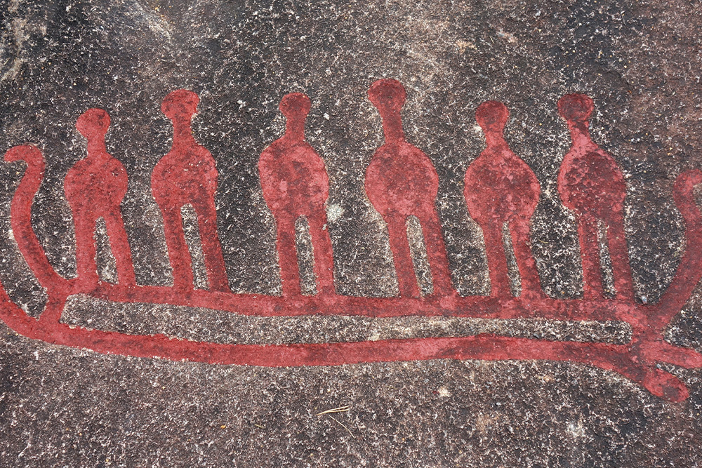 Prehistoric cave archeological cave carving of six men in a boat used to symbolize the deep meaning of a 6-word memoir