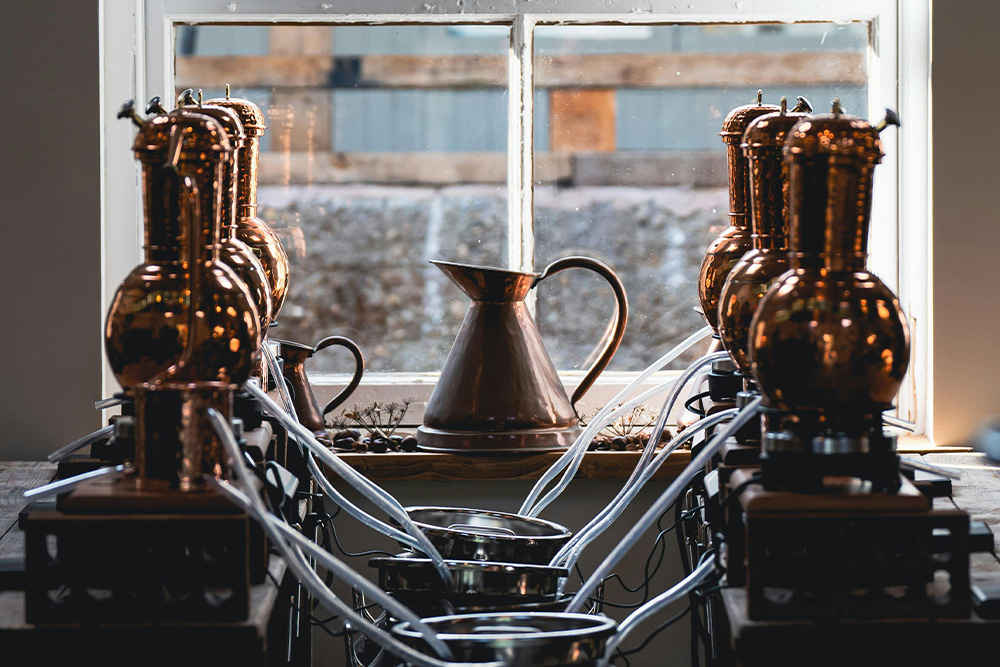 6 copper brewers are being distilled into three big kegs to represent the big moment of simplifying in the 6-word memoir writing process