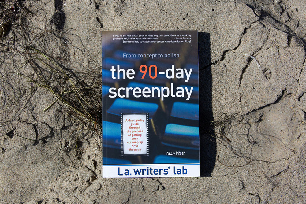 A copy of the 90 day screenplay rests on a beach to illustrate how to outline a screenplay