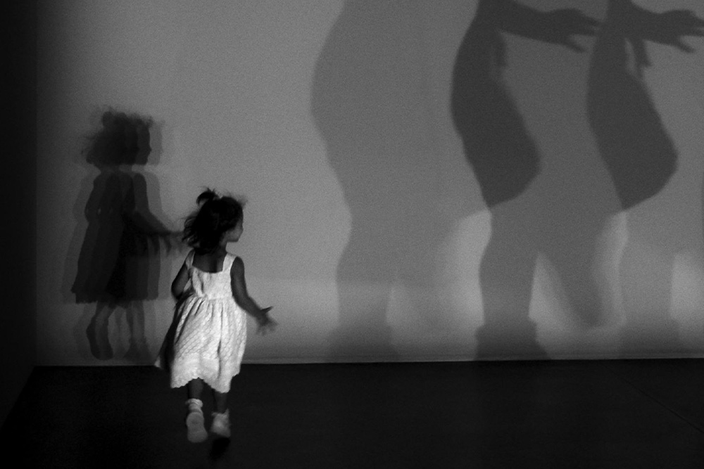 A girl and her shadow set against a larger version of her shadow are used to explain what goal a protagonist is chasing in how to outline a screenplay