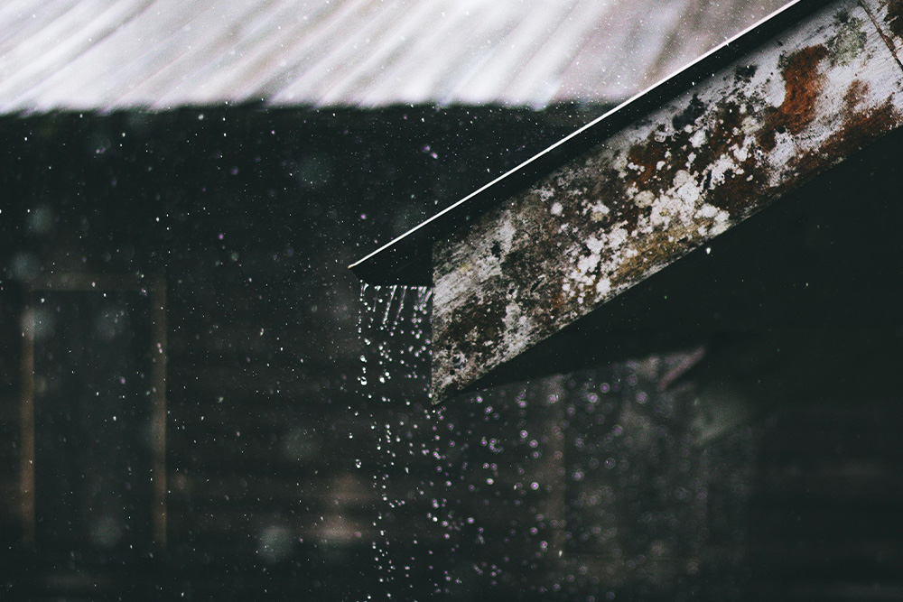 Rain falls on a peaceful rooftop as an example of what is onomatopoeia in a peaceful sense