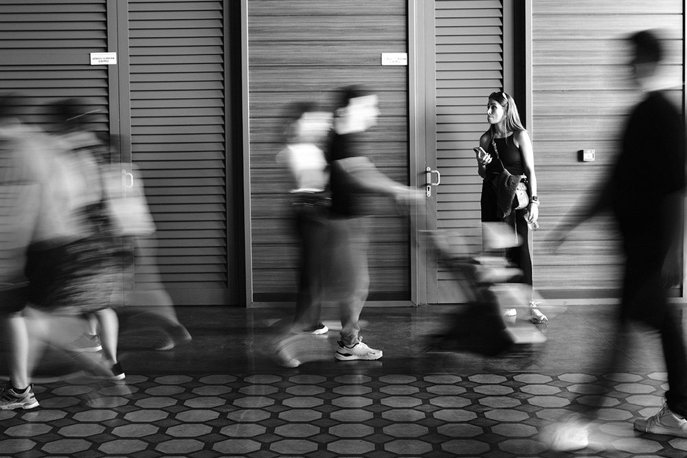 Pacing in writing is difficult for all writers. Imaged here is a woman who looks stuck while the world moves quickly around her.