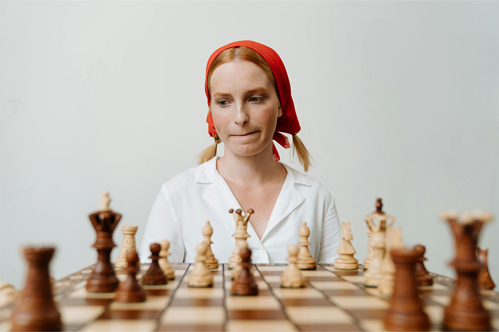 Getting through the messy middle pictured here, as a woman on the opposite end of a chessboard trying to figure out what to do next