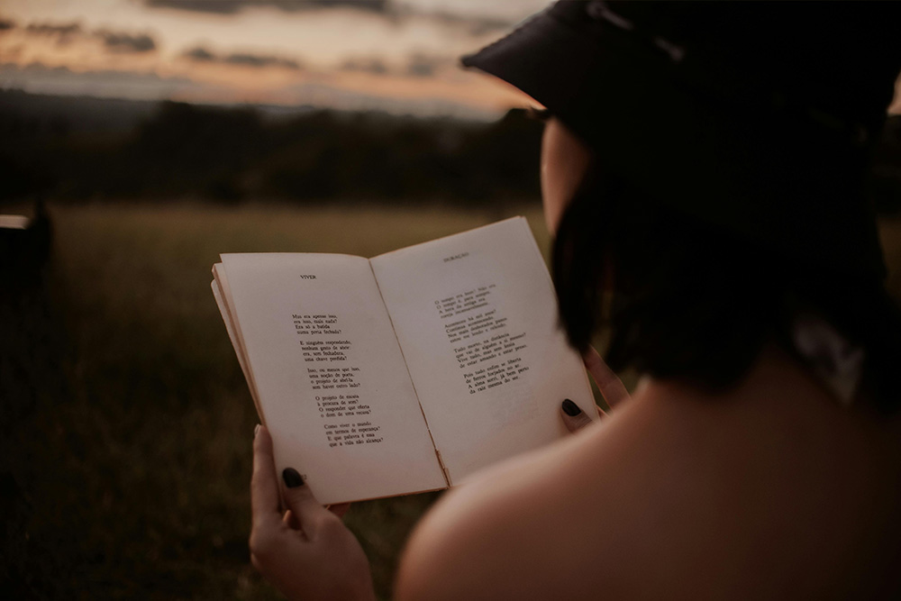 A woman reads poetry with multiple lines to suggest the beauty and necessity of quoting more than one line at a time sometimes