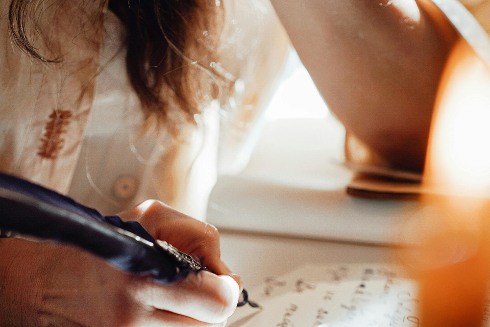 Someone writes freely with a very ornate looking pen in a fashion that elicits a freedom in writing that which a writer feels strongly about to get to the central conflict of a story