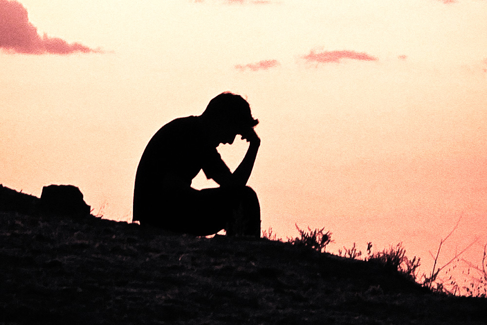Someone introspects on a hill by a beautiful sunset to suggest the importance of a protagonist surrendering in the parts of a story