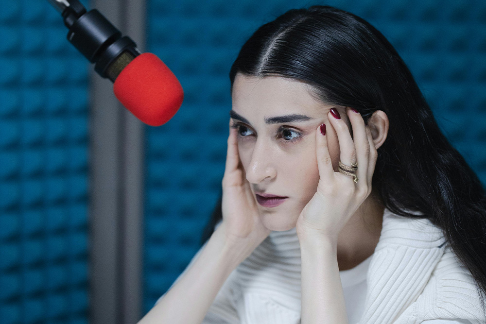 Removing intent with passive voice misuse creates a sense of not knowing what to say when in front of the microphone, like the woman pictured in the photo
