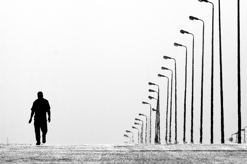 passive voice misuse puts a great distance between you and the reader, as shown by a A man walking in silhouette from afar.