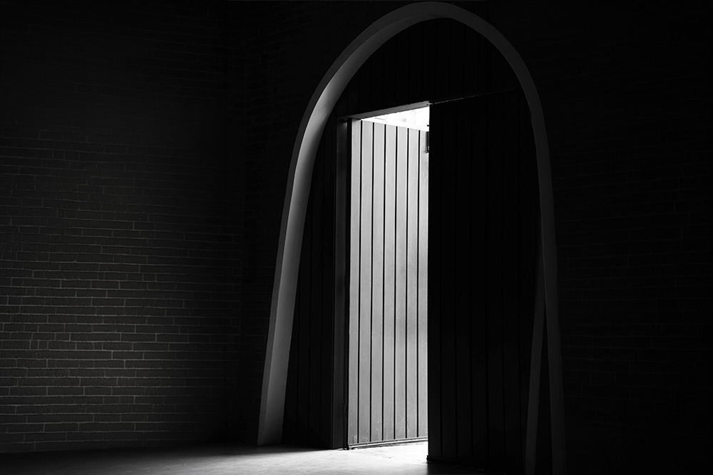 A door stands open and is too stark an image to be ignored, breaks the flow like in the text reference
