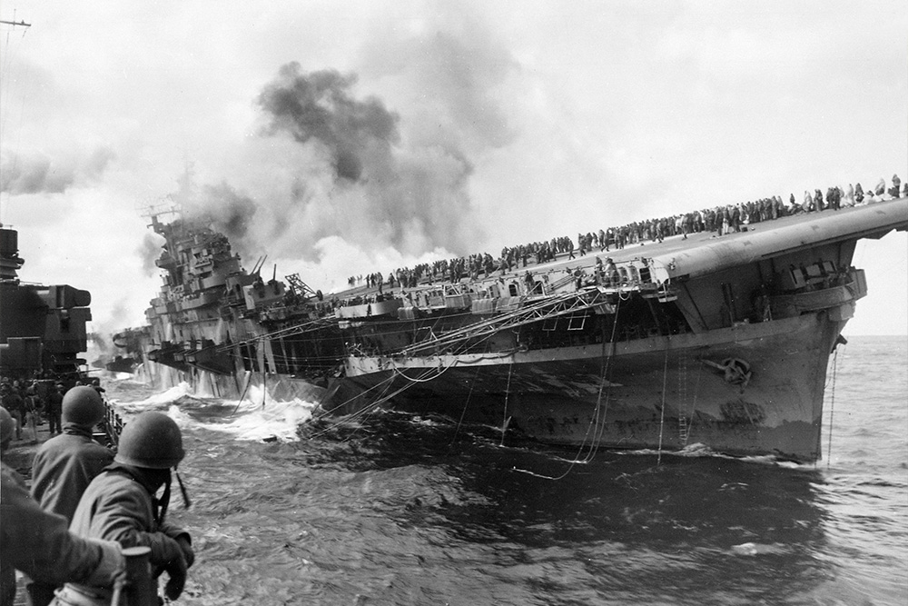 A picture of the USS Franklin carrier being attacked as a visual metaphor for conflict in plot development