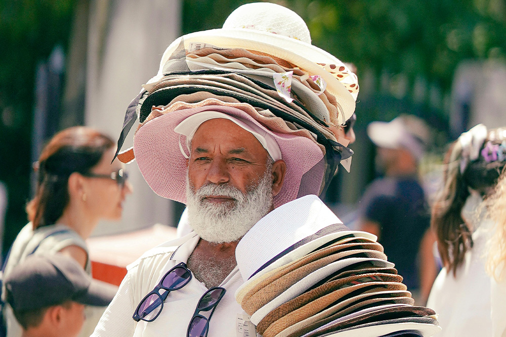 A man solemnly wears a lot of many hats that he needs to sell — is this what you want your writing to represent?