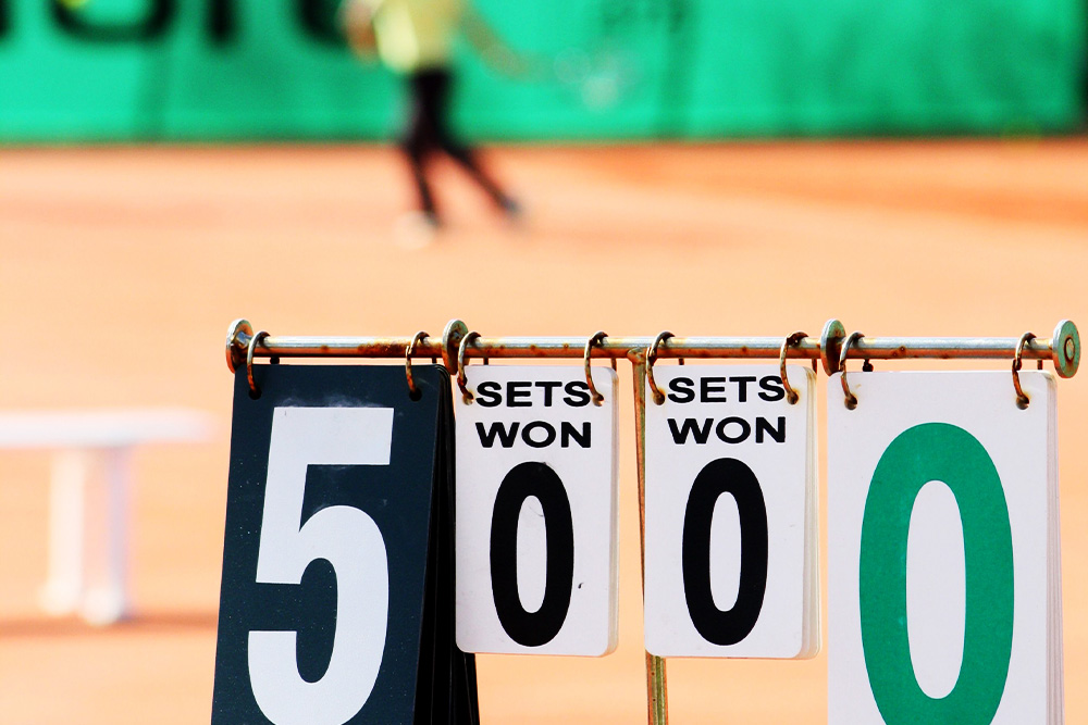 A strong losing score at a tennis match depicted on a scoreboard to suggest not to write to settle a score in advice on writing memoir