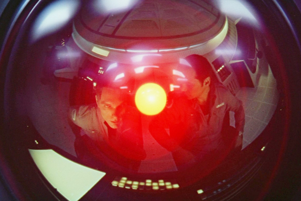 HAL from A Space Odyssey with the main character reflected in the orb as an example of character vs. technology conflict