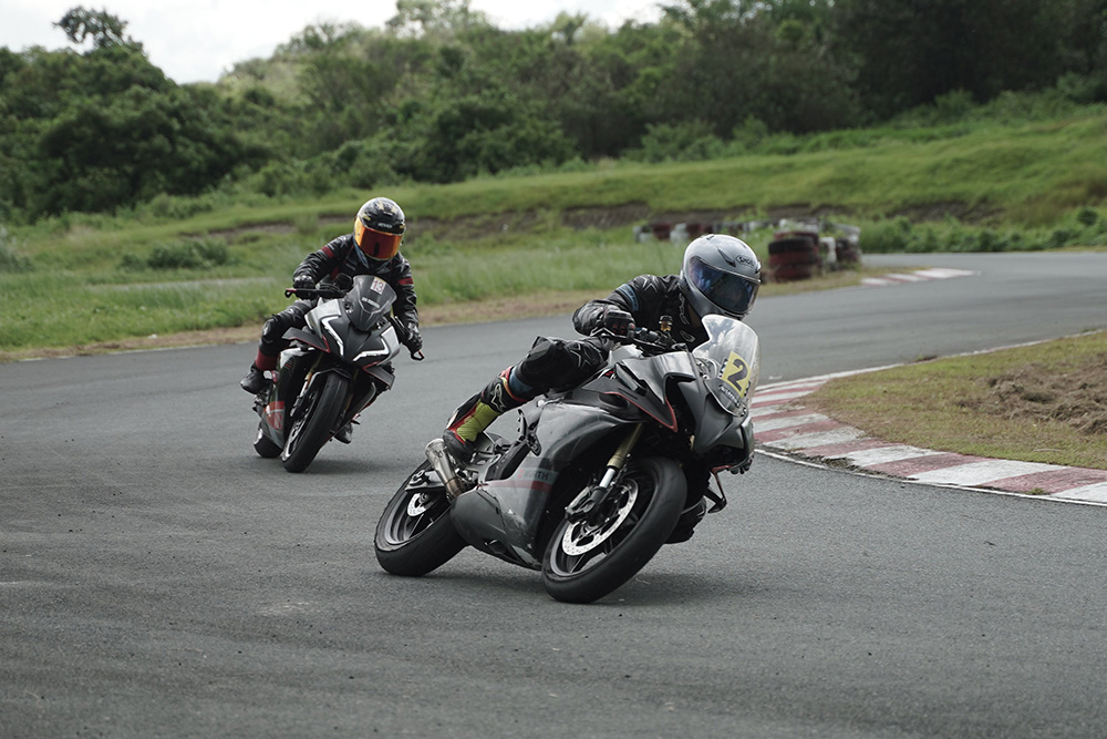 Motorcyclists on a curved track conveys the fast-paced action of a story following the fichtean curve