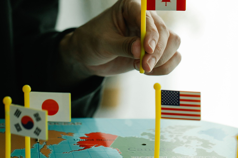 A map with flags from different nation states sitting on it suggests international protections in how to copyright a book