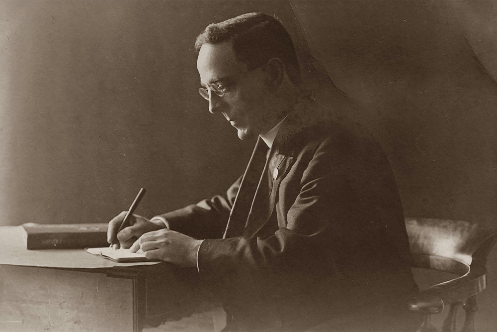 A man sitting alone at a desk in an old-timey photo suggests a timelessness and ethos that your query letter ought to take on