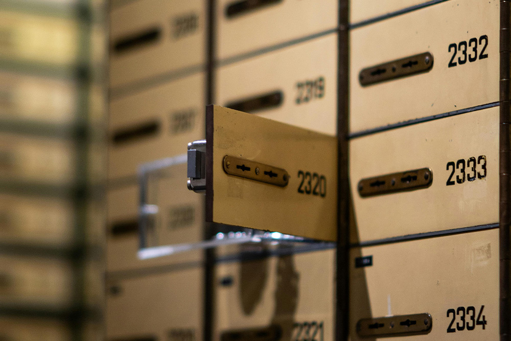 An image of an open lockbox suggests that the omniscient narrator is the keeper of a vault that can selectively reveal the right information to the audience at certain times