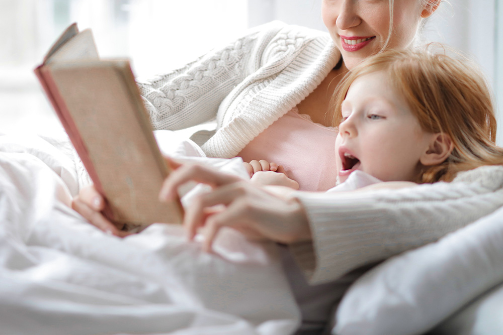 A mother and a daughter representing the inner child are reading the writing aloud to suggest the editing in practice part of revising vs. editing