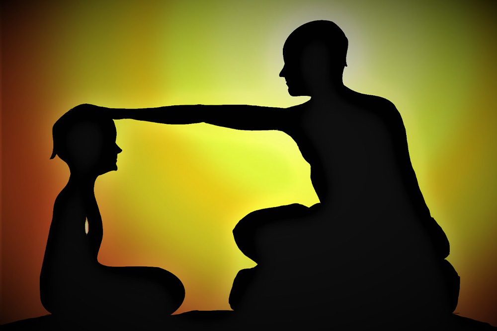 A boy with the hand of a guru placed on his head and a fire drawn over his heart is used to exemplify what the sage does in a story