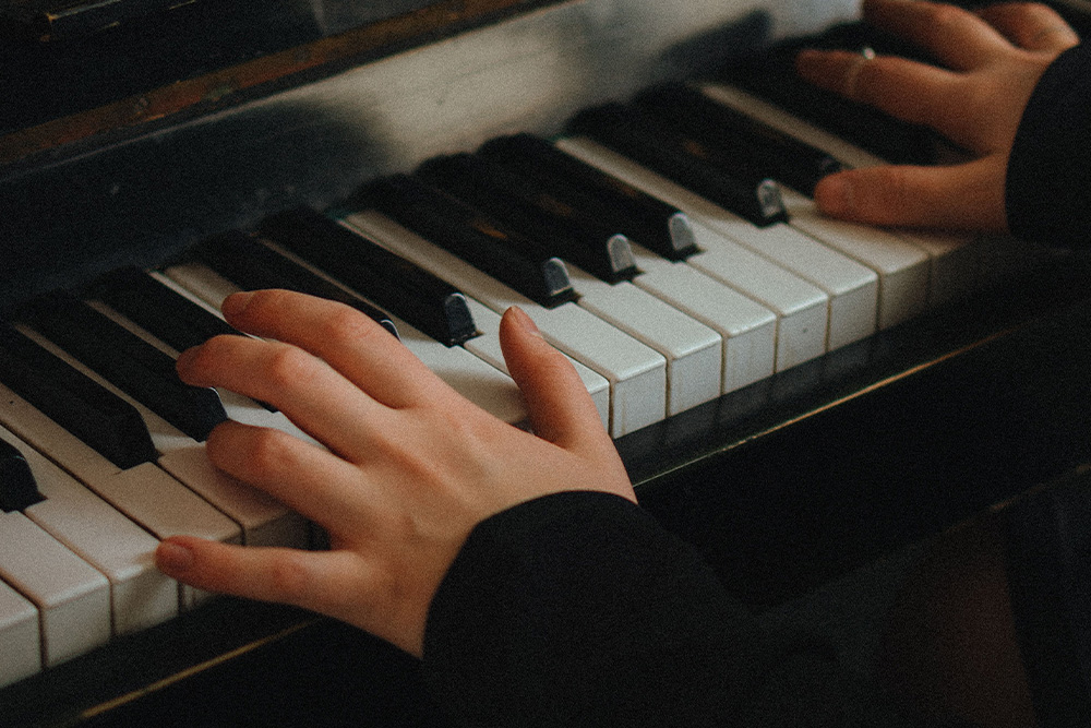 A person practices playing piano to suggest what is rhythm