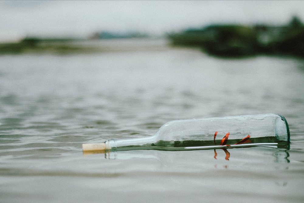 A message in a bottle is submerged below water to suggest that subtext matters more than dialogue tags