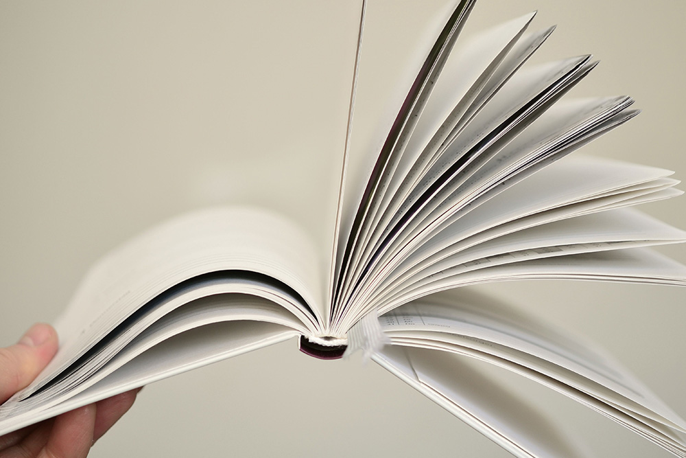 Empty pages flip out away from the reader — some books move faster than others.
