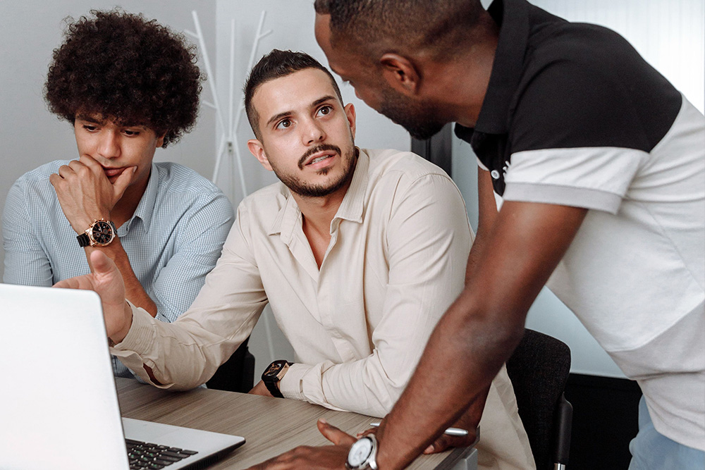 A man looks upset at someone who is giving him feedback to suggest receiving peer learning notes well
