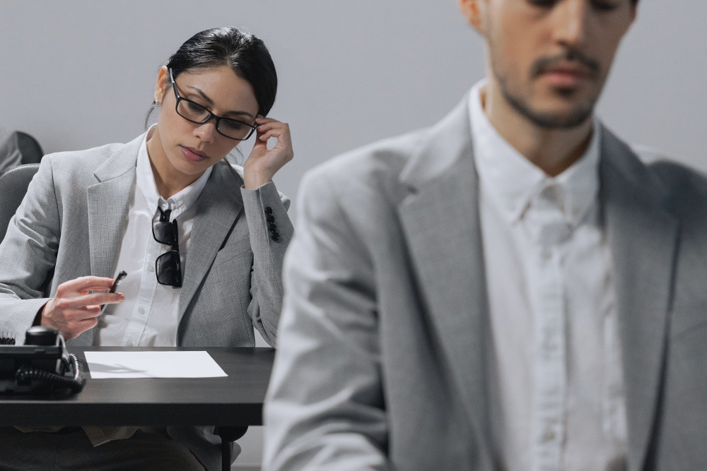 A woman sits in thought behind someone else in similar garb to suggest how peer learning accelerates professional growth