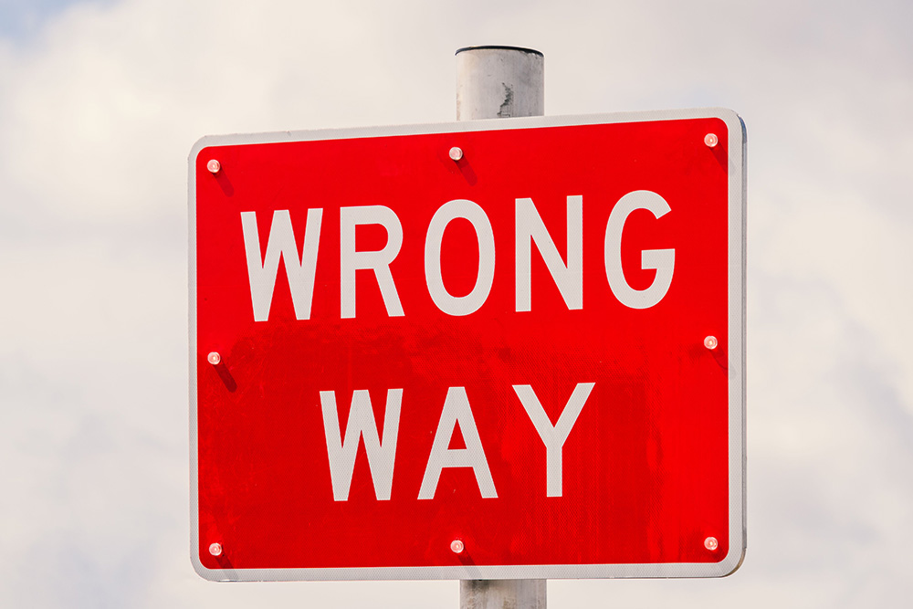 A sign that reads wrong way suggests mistakes that may be made when taking up the path to writing challenges