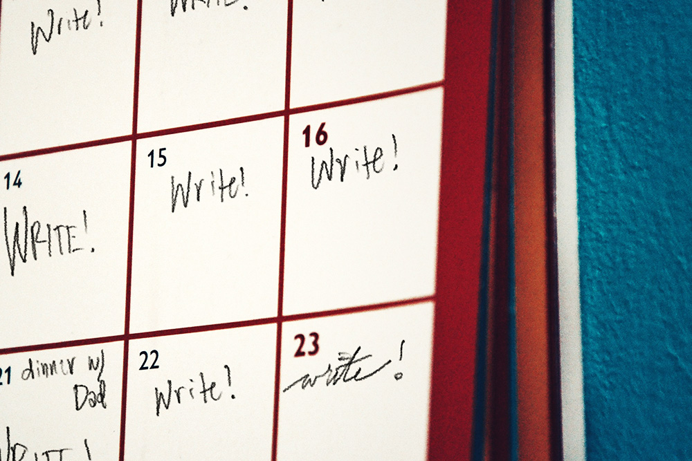 A daily calendar that has a bunch of notes saying to "write!" suggesting that writing challenges offer a daily rigor.