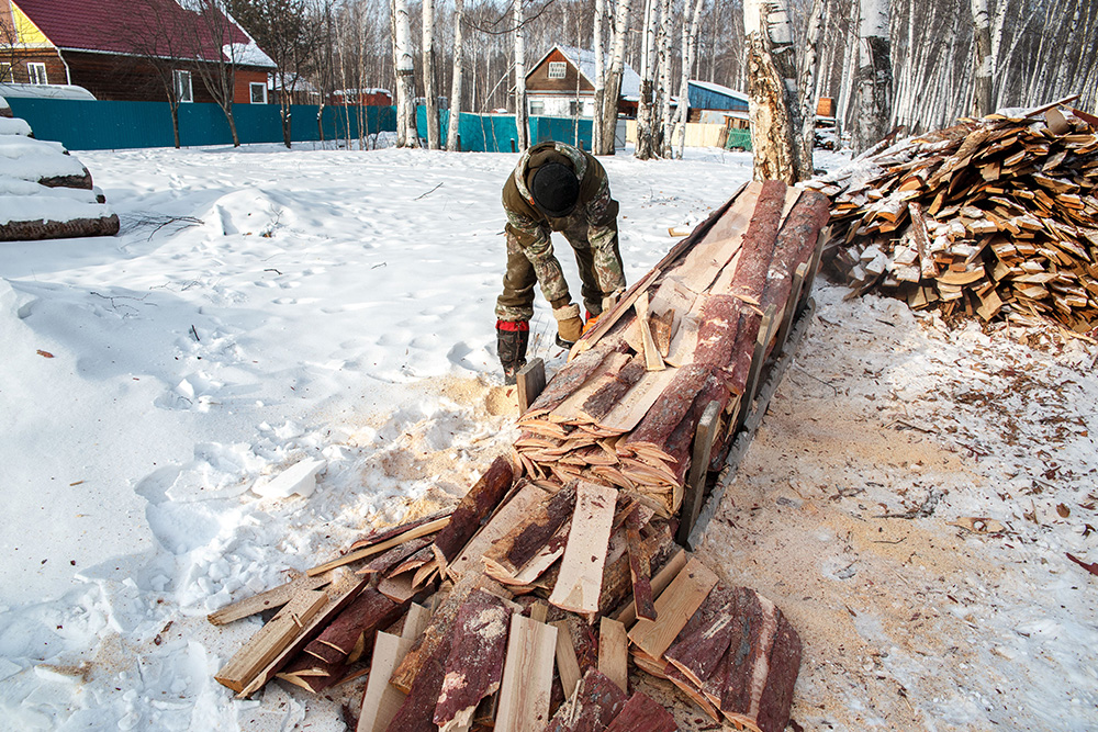 Logger breaking up wood blocking a roadway to suggest what actually gets cut in abridged vs. unabridged novels